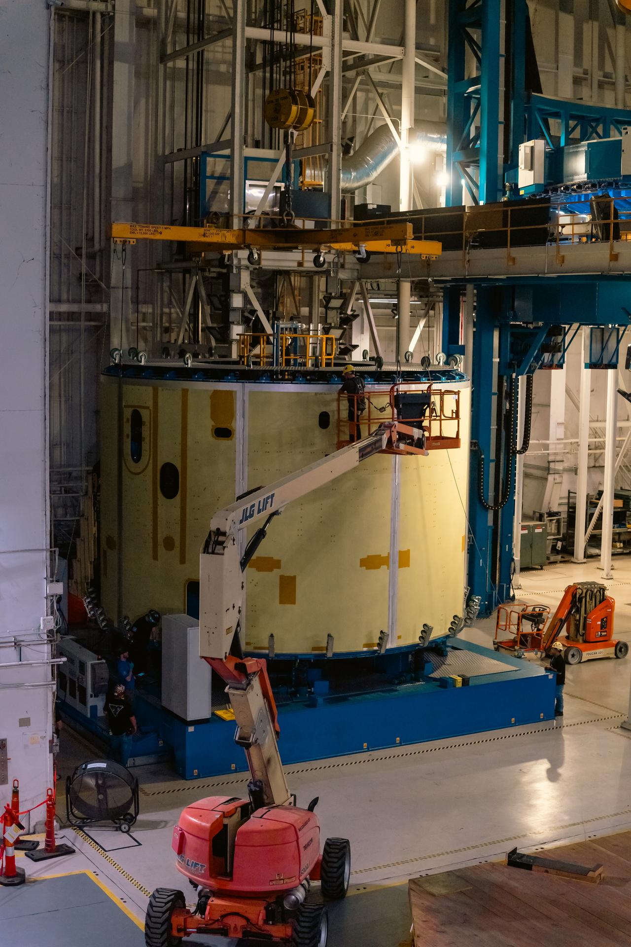 Teams at Michoud Assembly Facility in New Orleans load the 25-foot-long engine section barrel into the vertical assembly center on Aug. 5, 2026. The engine section will be used on the SLS (Space Launch System) rocket’s core stage for the agency’s Artemis V mission. On the vertical assembly center tooling, teams will mate the flight hardware to a ring, which will serve as an attachment point for the liquid hydrogen tank later in the production process.    The engine section is one of five major elements that make up the 212-foot-tall SLS rocket stage; and houses various avionic systems, the engine thrust structure, and four RS-25 engines. The core stage produces more than two million pounds of thrust to help launch NASA’s Orion spacecraft, astronauts, and supplies beyond Earth’s orbit and to the lunar surface for Artemis.
